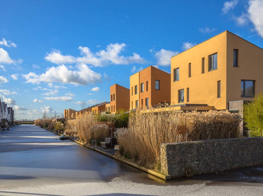 modern-residential-buildings-along-a-canal-under-b-2026-03-24-09-52-58-utc (1)